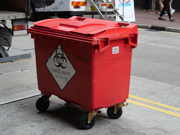 Red clinical waste bin for biohazard and sharps disposal