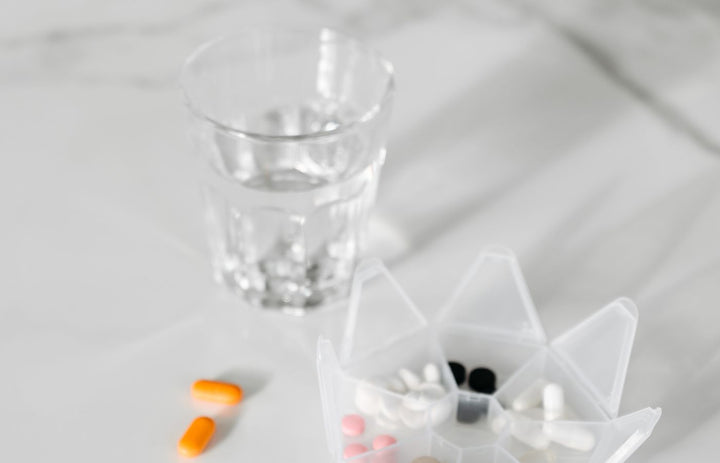 Cold and flu supplies: medication, water and a thermometer