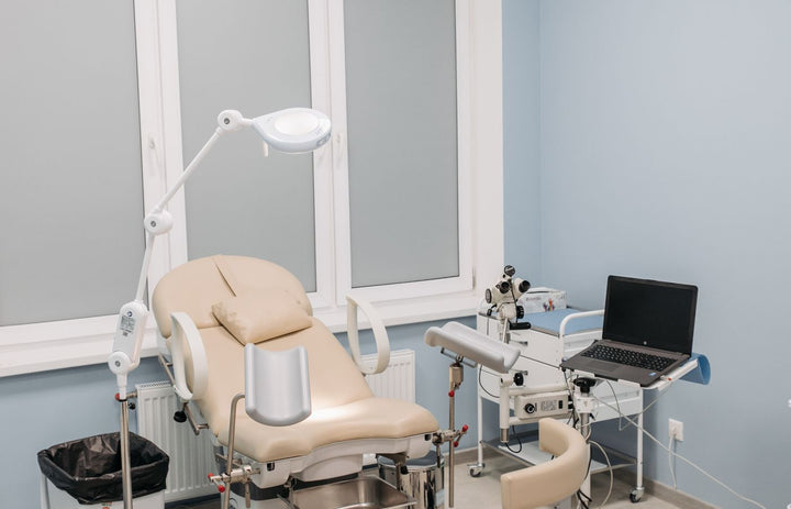 Clean modern medical clinic exam room with equipment