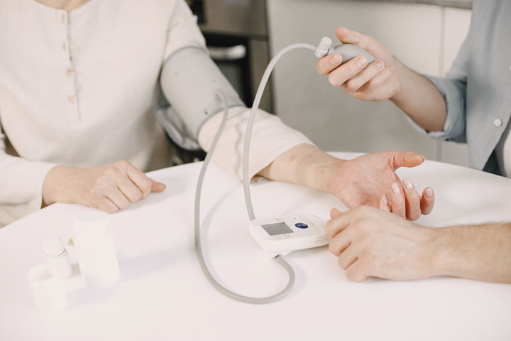 Taking a patient's blood pressure with an upper-arm monitor