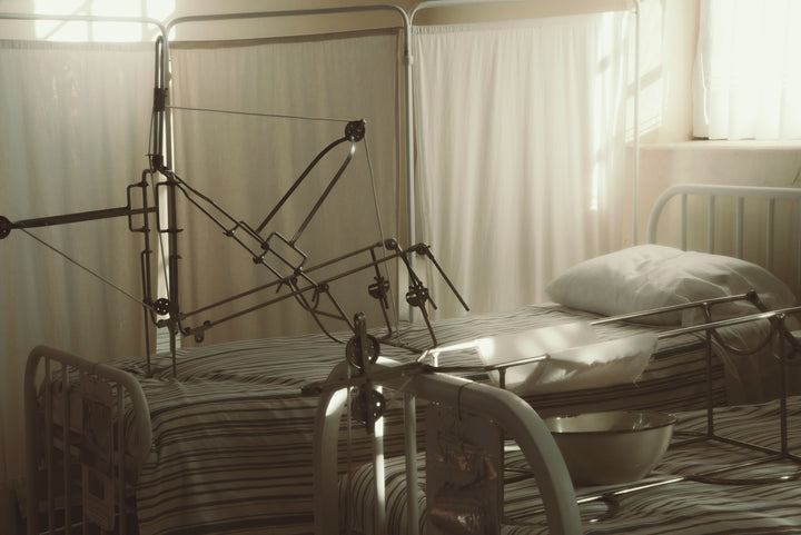 Adjustable hospital beds with medical equipment in a care facility