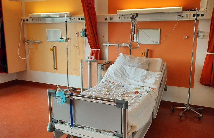 Adjustable hospital bed and equipment in a modern patient room