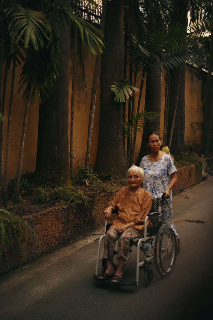 Caregiver assisting a patient with a transfer