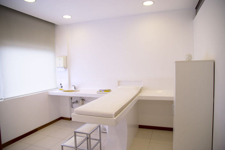 Medical exam table in a clean clinic room by a window