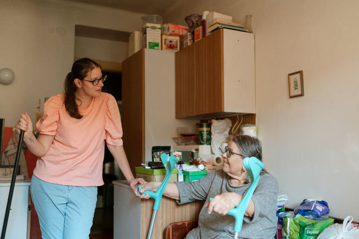 Caregiver supporting an older adult at home