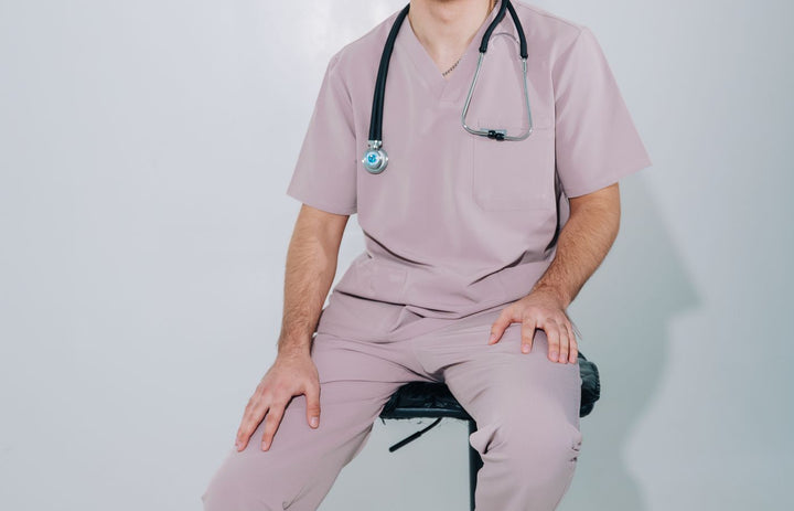 Clinician seated on a medical stool with a stethoscope
