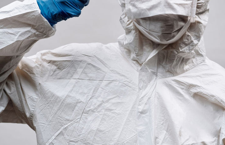 Healthcare worker in PPE coverall, mask and gloves