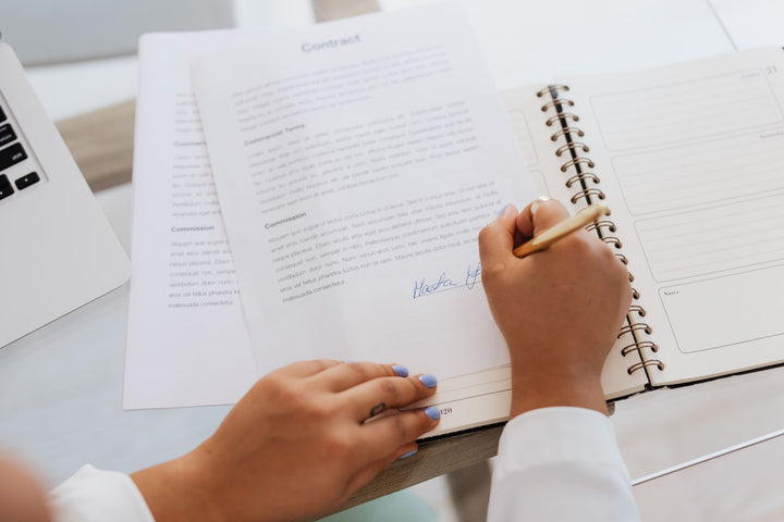Signing a purchase order contract at an office desk