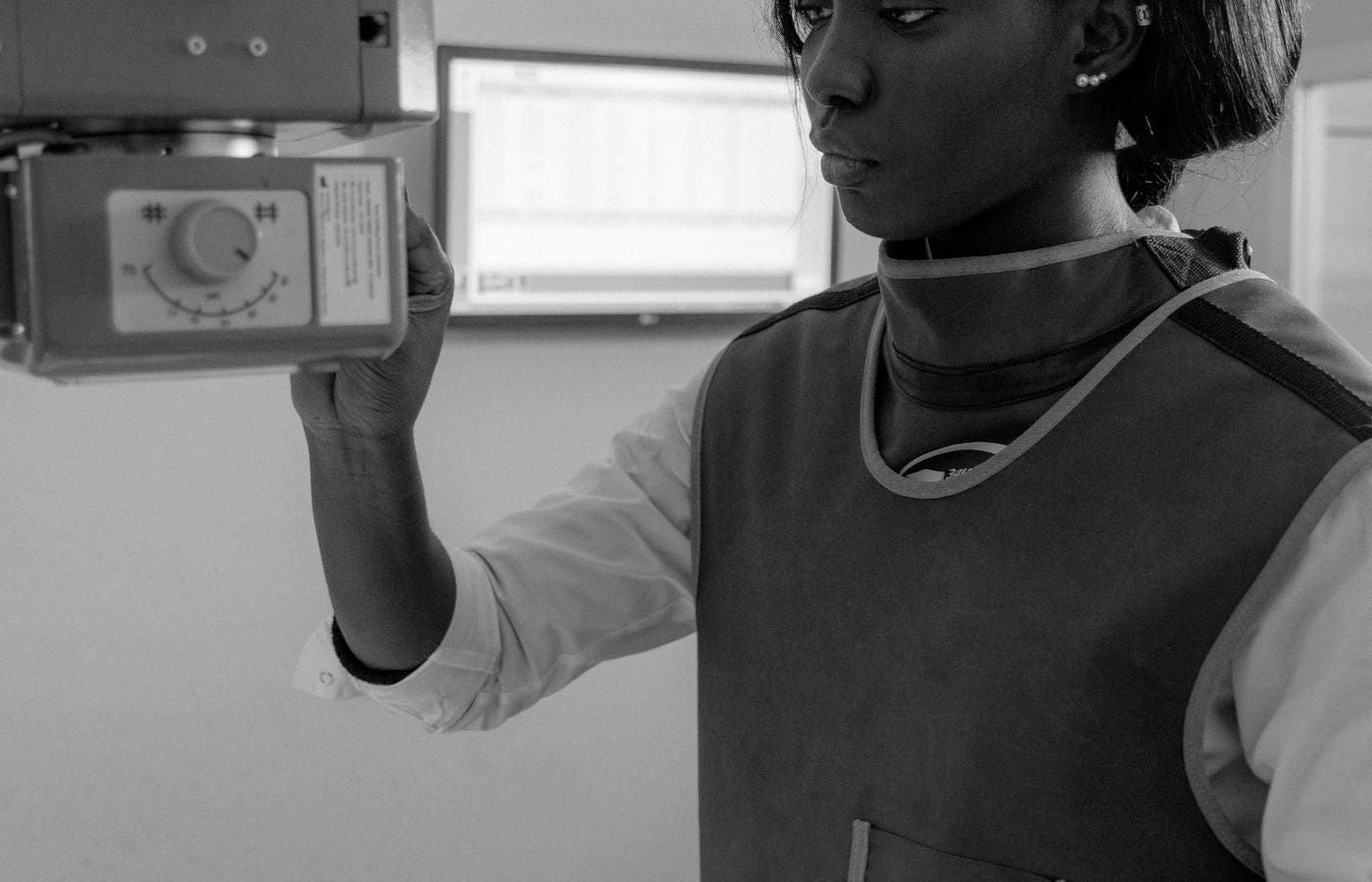 Technician operating an X-ray machine wearing protective gear