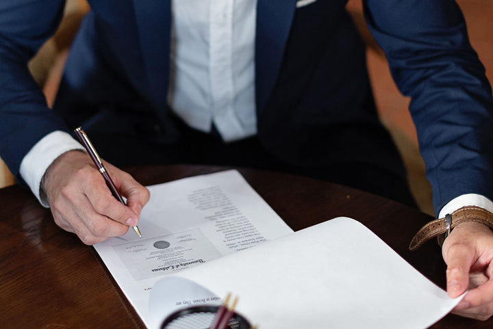 Signing a service plan and warranty agreement at a desk