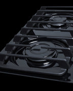 30" wide cooktop with four sealed burners, black porcelain finish, and cast iron grates; made in the USA - Detail